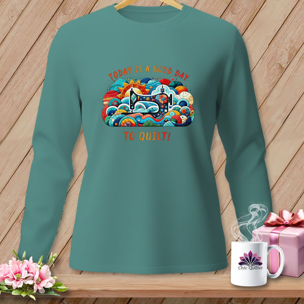 Teal long-sleeve shirt with "Today is a good day to quilt!" text and sewing machine graphic.