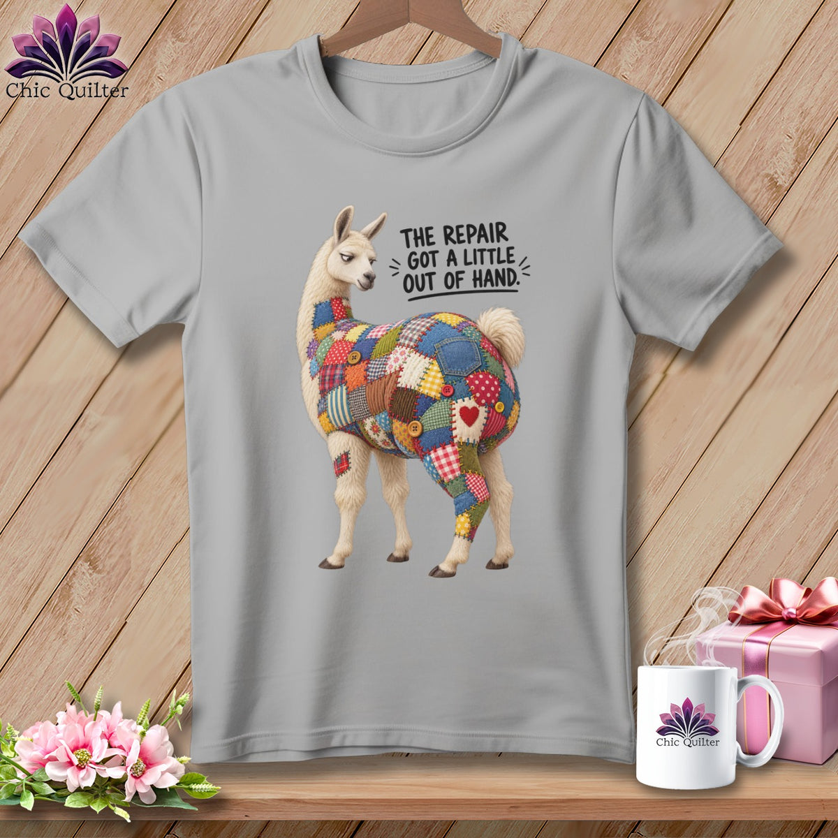 Gray t-shirt with llama covered in patchwork, text "The repair got a little out of hand."