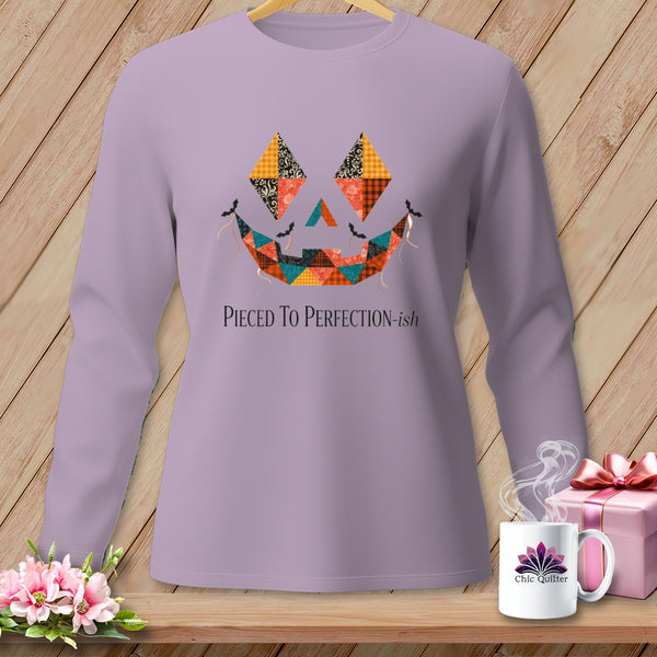 Lavender long-sleeve shirt with a patchwork jack-o'-lantern face and text.