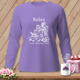 Purple long-sleeve shirt with a graphic of a woman relaxing with a cup of tea and quilting pieces.