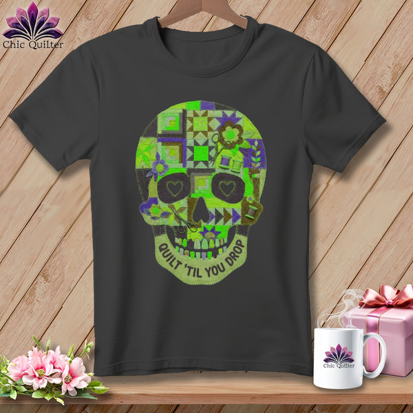 Dark gray t-shirt with a quilted skull graphic that says "Quilt 'Til You Drop."