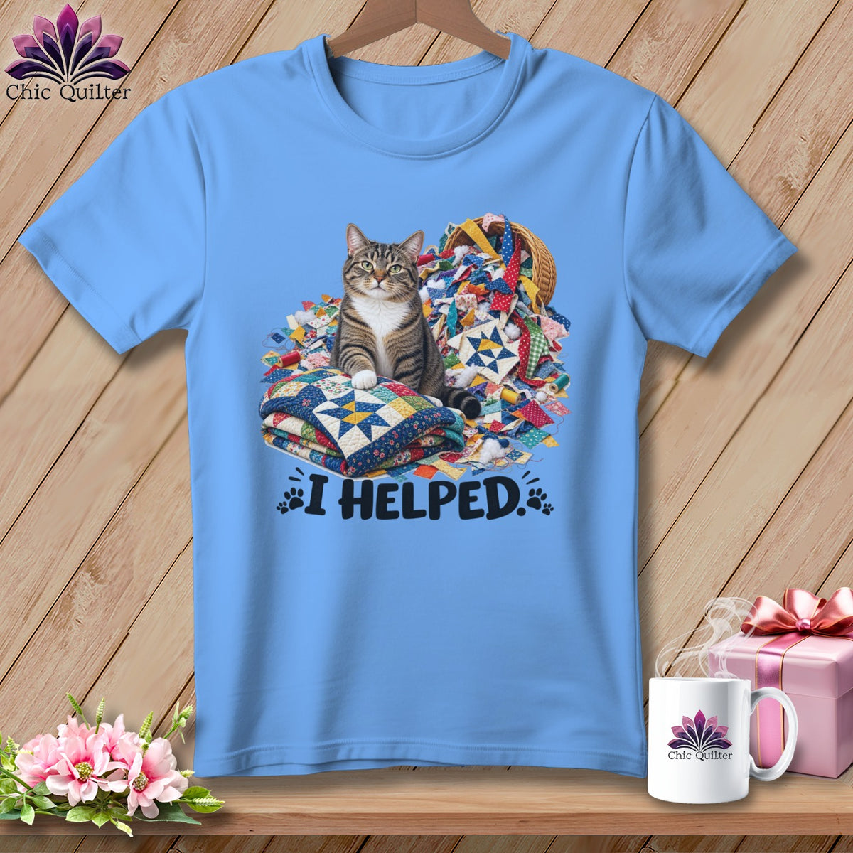 Blue t-shirt with a tabby cat sitting on quilts with "I HELPED." text.