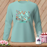 Mint long-sleeve shirt with ghosts sewing and crafting, on a wooden background.