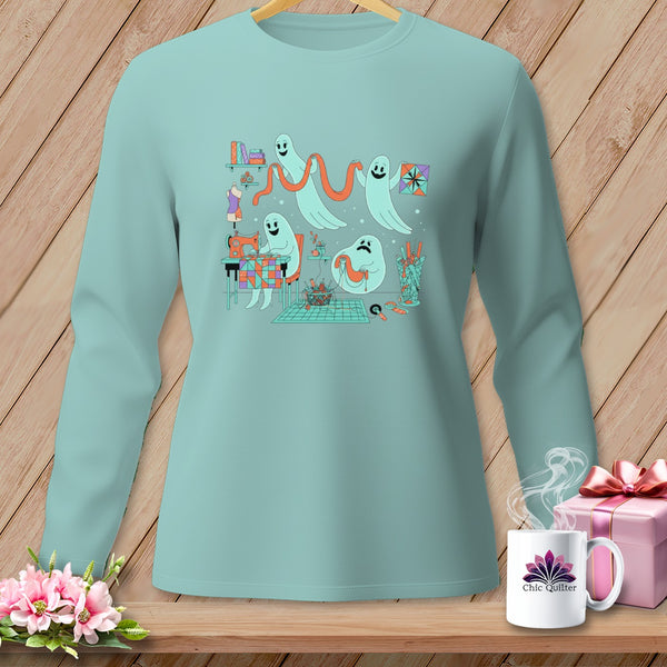 Mint long-sleeve shirt with ghosts sewing and crafting, on a wooden background.