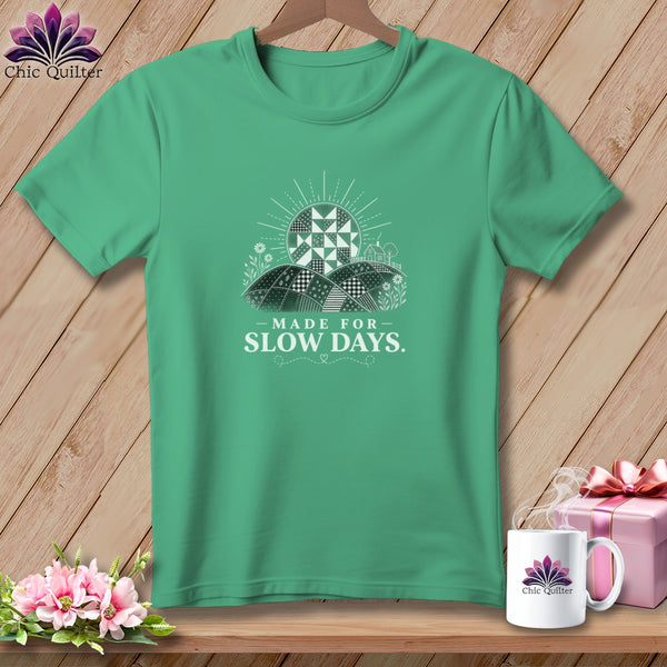 Teal t-shirt with "Made for Slow Days" text and a quilt-like sun design.