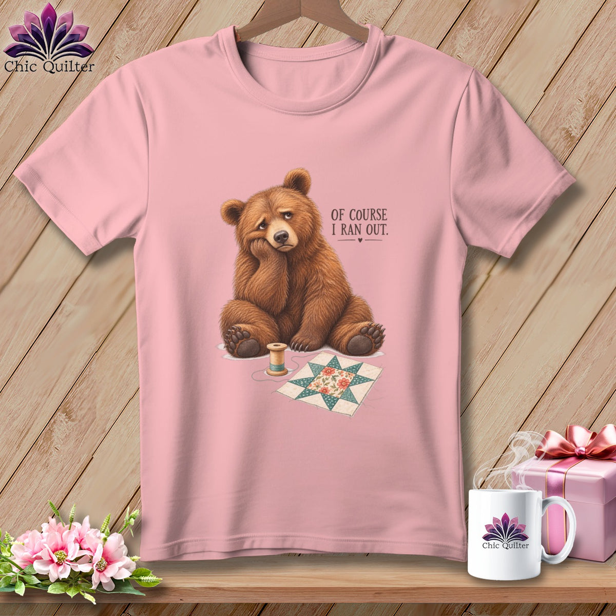 Pink t-shirt with a sad bear, sewing supplies, and text "OF COURSE I RAN OUT."