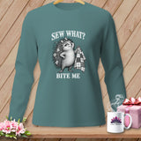 Teal long-sleeve shirt featuring a graphic of a hedgehog holding a quilt and text reading Sew What Bite Me.