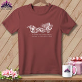 Maroon t-shirt with a whimsical mermaid holding a quilt, and text about returning to the quilt shop.