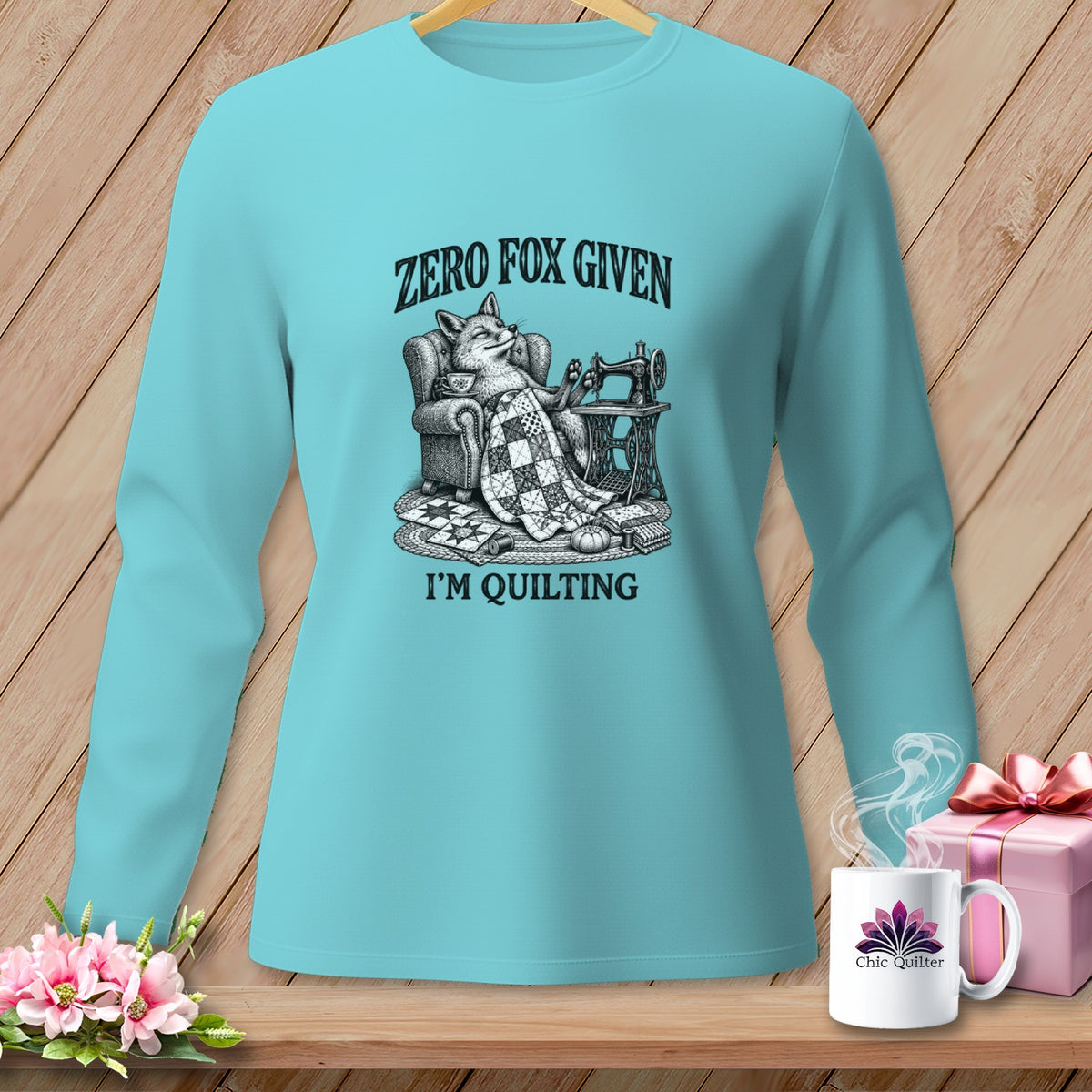 Teal long-sleeve shirt with "Zero Fox Given, I'm Quilting" graphic.