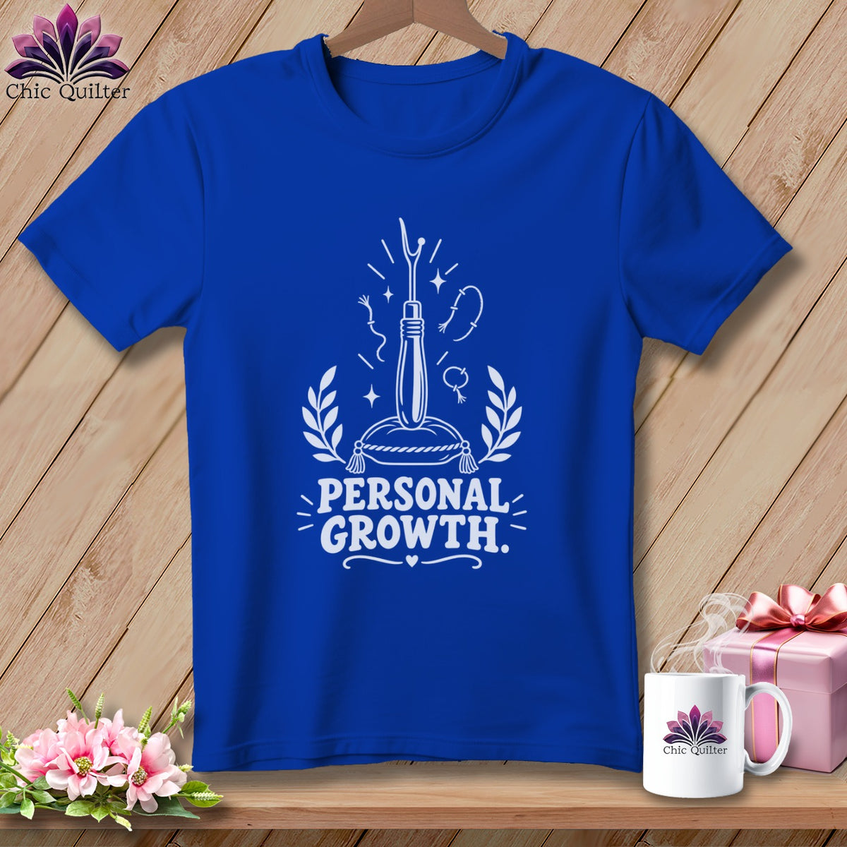 Royal blue t-shirt with "Personal Growth" graphic featuring sewing tools.