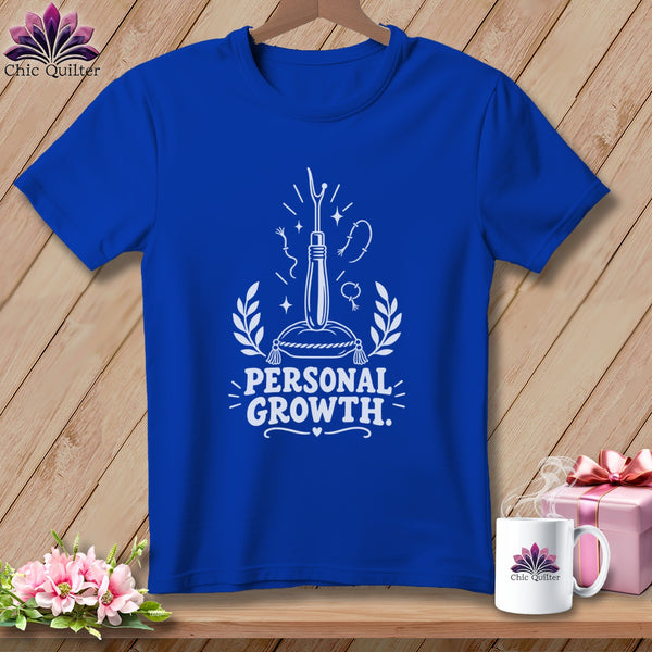 Royal blue t-shirt with "Personal Growth" graphic featuring sewing tools.