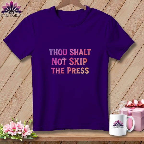 Purple t-shirt with "Thou Shalt Not Skip The Press" text.