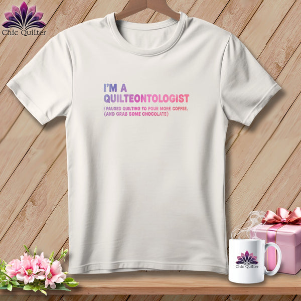 White t-shirt with "I'm a Quilteontologist" and coffee/chocolate text.