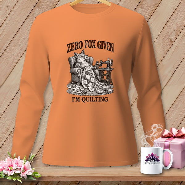 Orange long-sleeve shirt with fox at sewing machine, "ZERO FOX GIVEN I'M QUILTING" text.