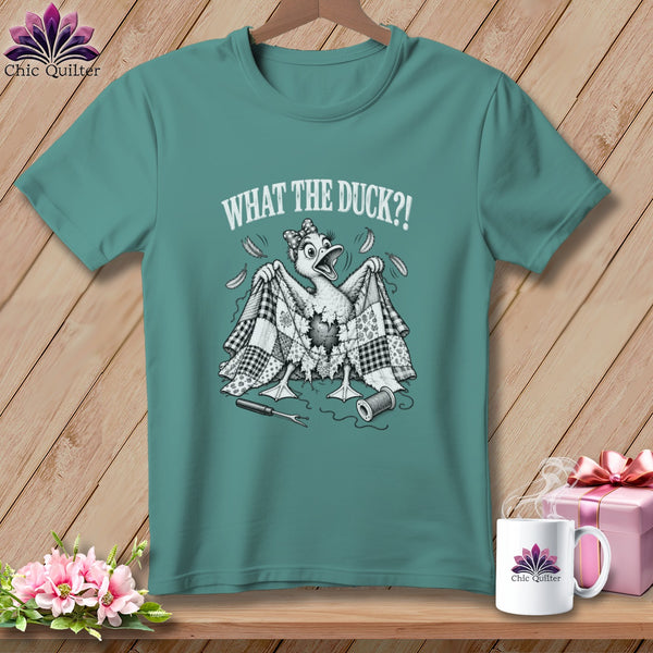 Teal t-shirt featuring a cartoon duck holding a patchwork quilt and the text "WHAT THE DUCK?!".