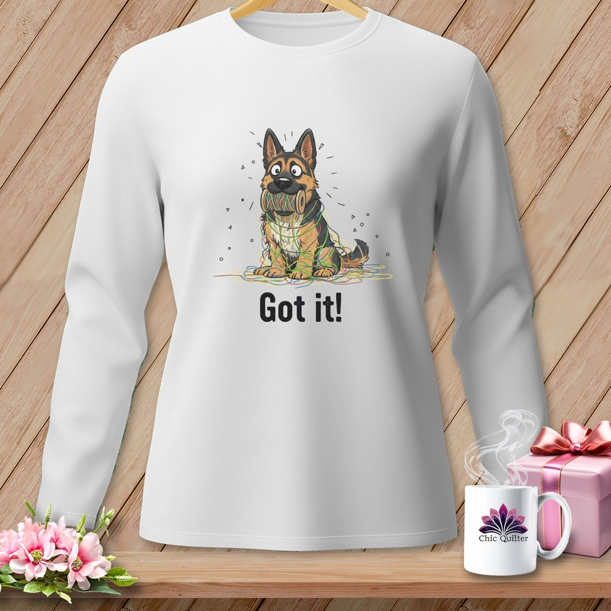 German Shepherd tangled in colorful yarn on white sweatshirt with "Got it!" text.
