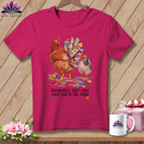 Two chickens, one with a quilt-like tail, stand on fabric scraps with scissors and a thimble.