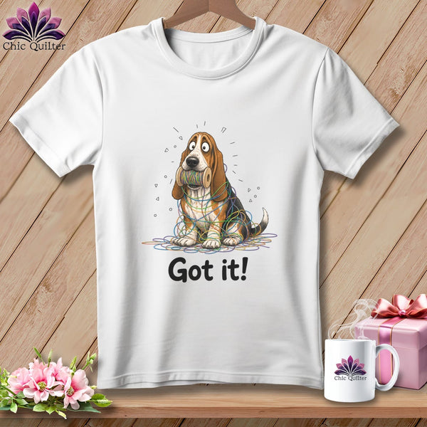 White t-shirt with basset hound tangled in colorful yarn, saying "Got it!".