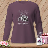 Long sleeve shirt with quilting design, needle, thread, and scissors. Text reads 