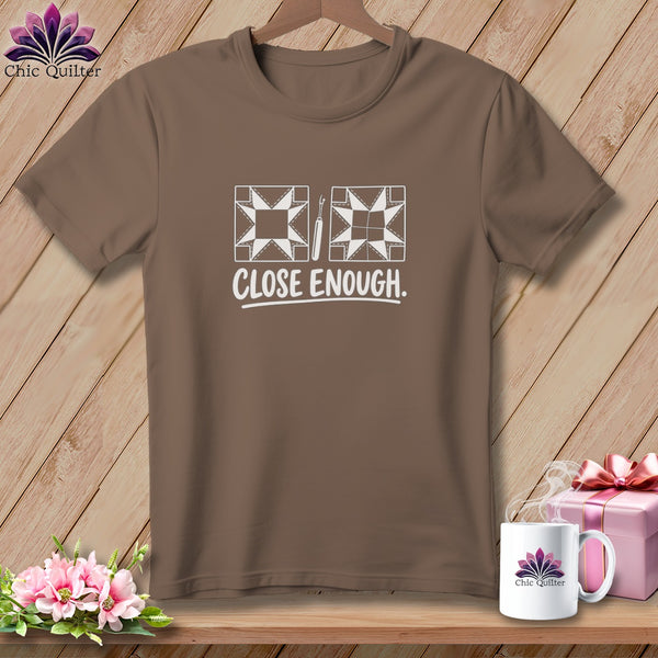 Brown t-shirt with white quilt block design and "CLOSE ENOUGH." text.