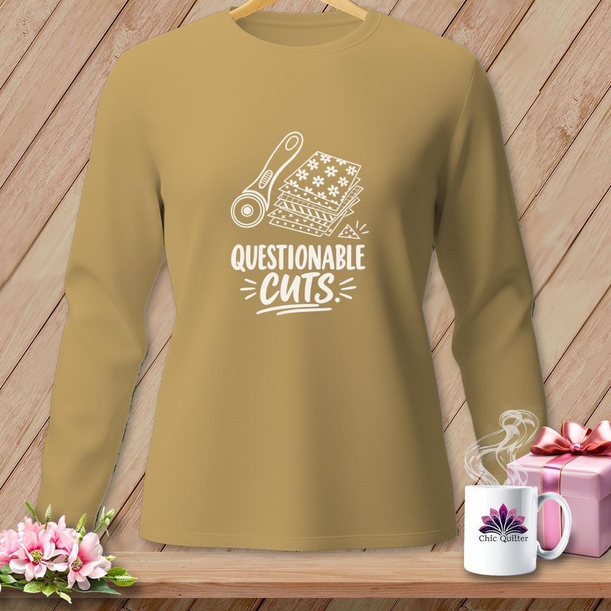 Long sleeve tan shirt with "Questionable Cuts" text and sewing graphics.