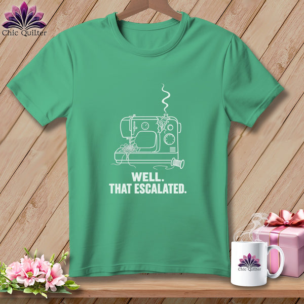 Green t-shirt with white line art of a sewing machine and text "WELL. THAT ESCALATED."