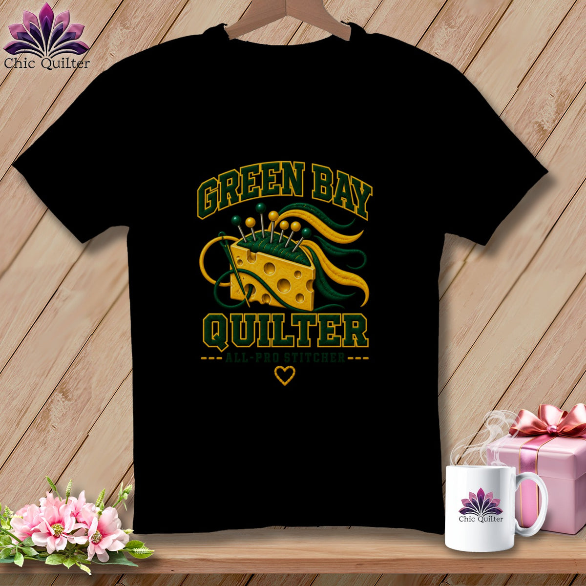 Black t-shirt featuring Green Bay Quilter text with a cheese wedge pin cushion, green and gold thread.