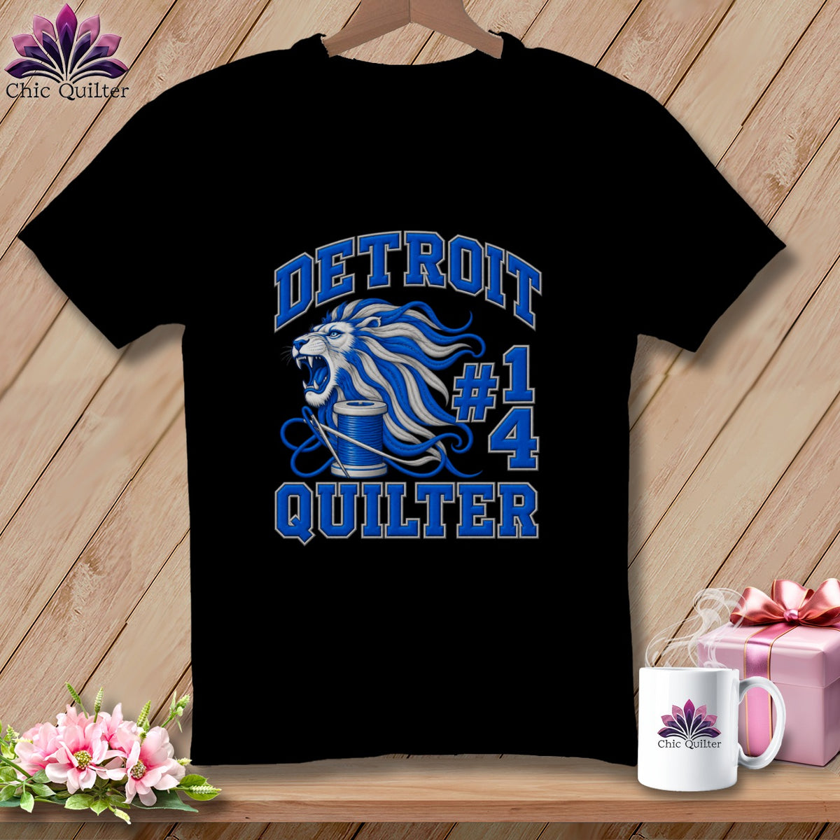 Black t-shirt featuring a blue and white graphic with a lion, spool of thread, and text reading Detroit Quilter.