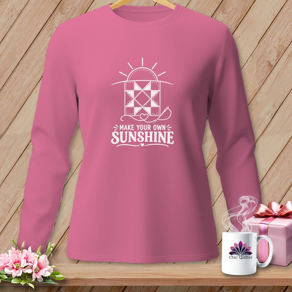 Pink long-sleeve shirt with "Make Your Own Sunshine" quilt graphic and sun.