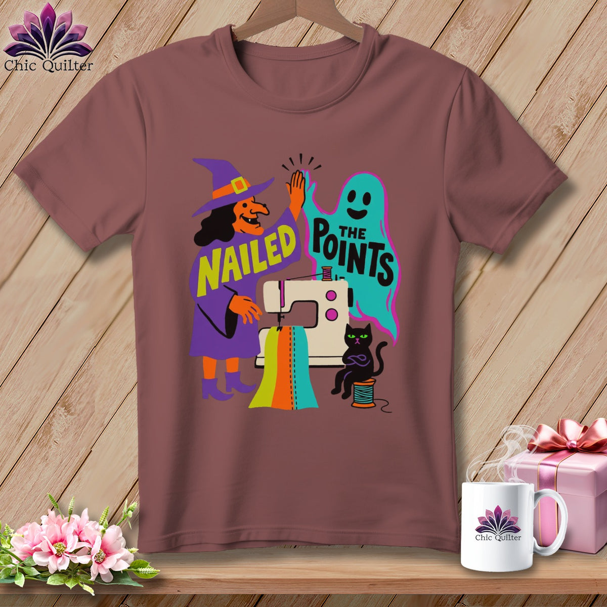 Witch and ghost giving high-five with sewing machine, cat, and text "Nailed the Points".