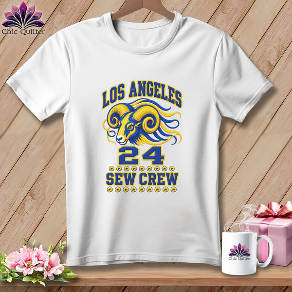 White t-shirt on a wooden background featuring a Los Angeles Rams graphic with the text "SEW CREW".