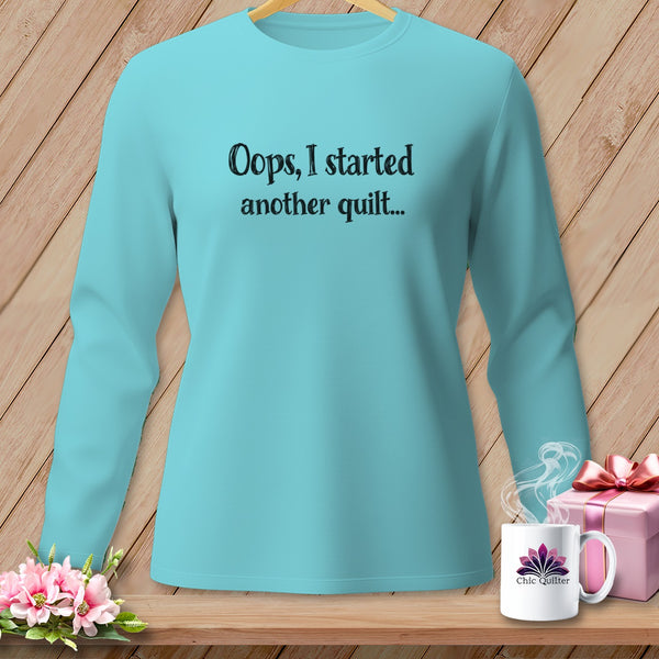 Turquoise long-sleeve shirt with "Oops, I started another quilt..." text.