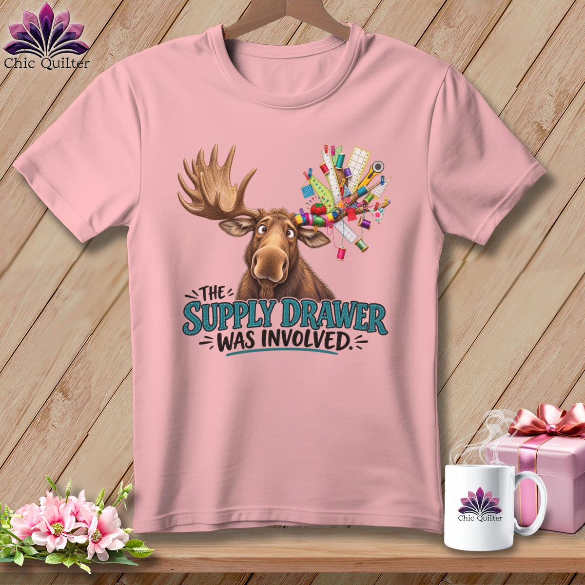 Moose with sewing supplies on antlers, text "The Supply Drawer Was Involved."