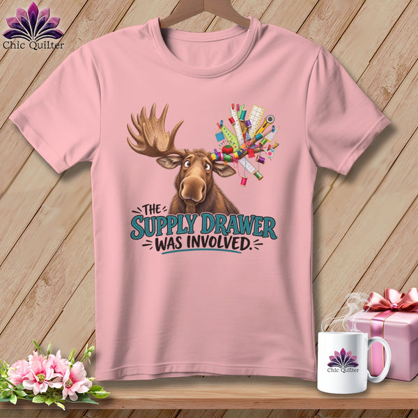 Moose with sewing supplies on antlers, text "The Supply Drawer Was Involved."