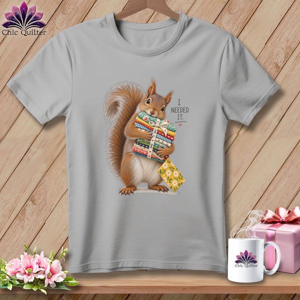 Squirrel holding stack of fabrics, text reads "I NEEDED IT."