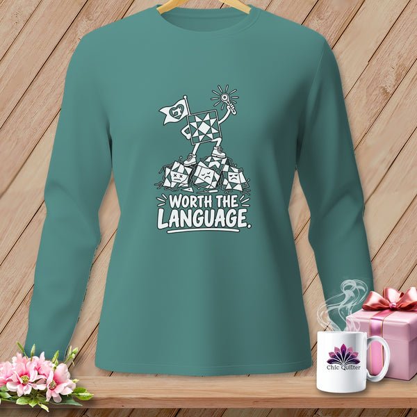 Teal long-sleeve shirt with cartoon quilt block and "Worth the Language" text.