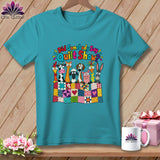 Teal t-shirt featuring cartoon farm animals behind a patchwork quilt, with the text Did Somebody Say Quilt Show?