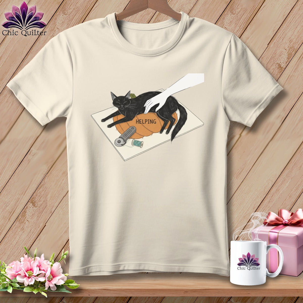 Cream t-shirt graphic: black cat on pumpkin with sewing notions and text "HELPING".