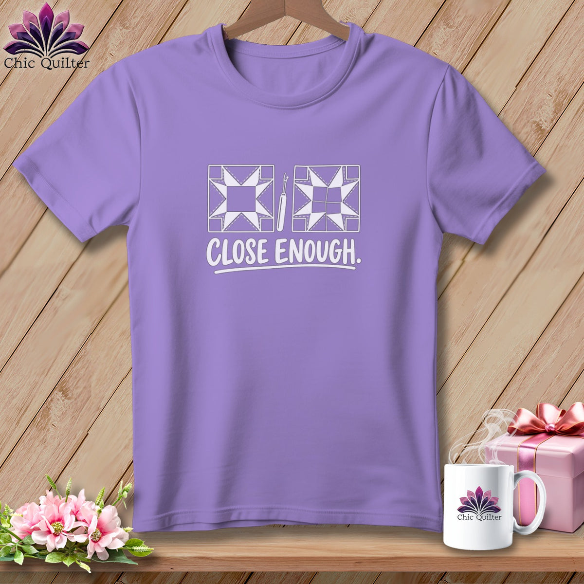 Lavender t-shirt with white quilting design and text "CLOSE ENOUGH."