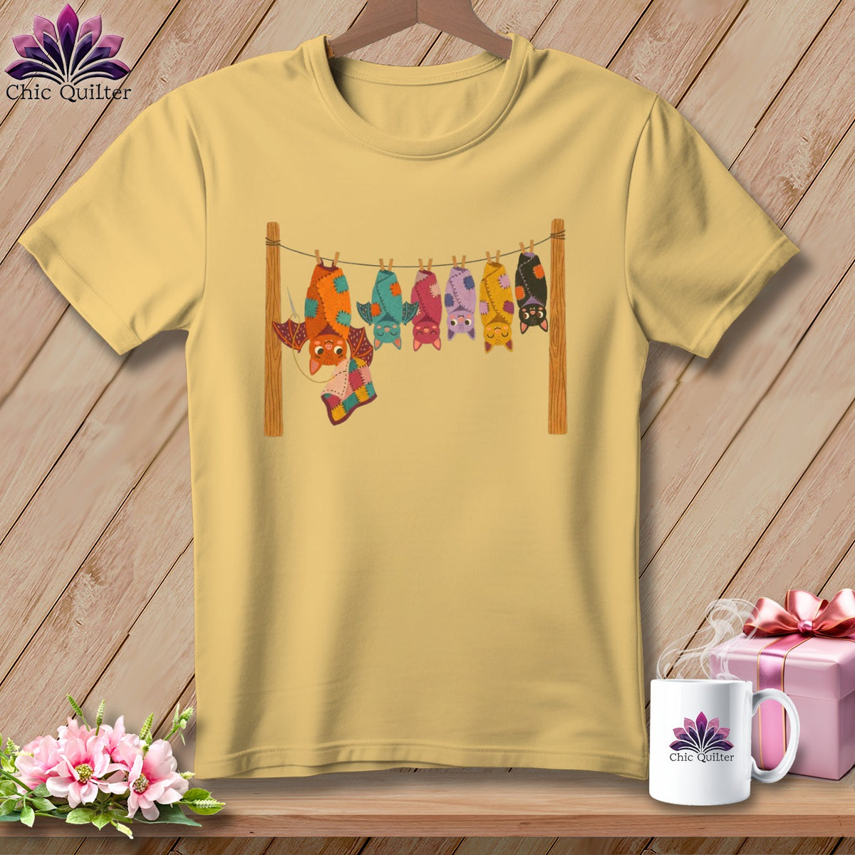 Yellow t-shirt with a row of colorful, hanging cartoon bats and "Chic Quilter" logo on mug.