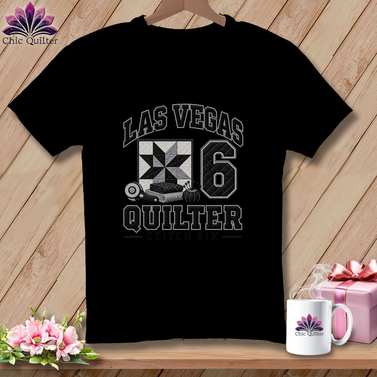 A black t-shirt featuring a Las Vegas Quilter graphic with a quilt block and rotary cutter.