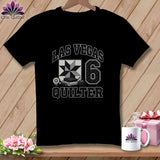 A black t-shirt featuring a Las Vegas Quilter graphic with a quilt block and rotary cutter.