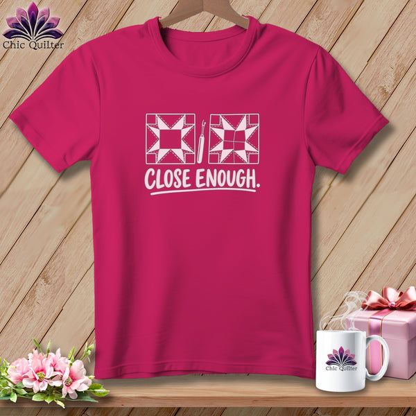 Pink t-shirt with "CLOSE ENOUGH." text and quilting block graphics.