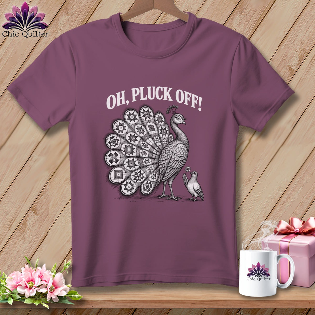 Mauve short-sleeve t-shirt with a peacock illustration and the text OH PLUCK OFF! printed in white.