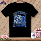 Black t-shirt featuring blue and white Detroit Quilter text, a folded quilt stack, and a coffee mug.