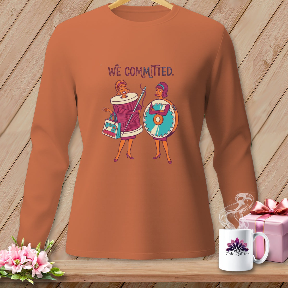 Long sleeve shirt with "WE COMMITTED" text and two cartoon women.