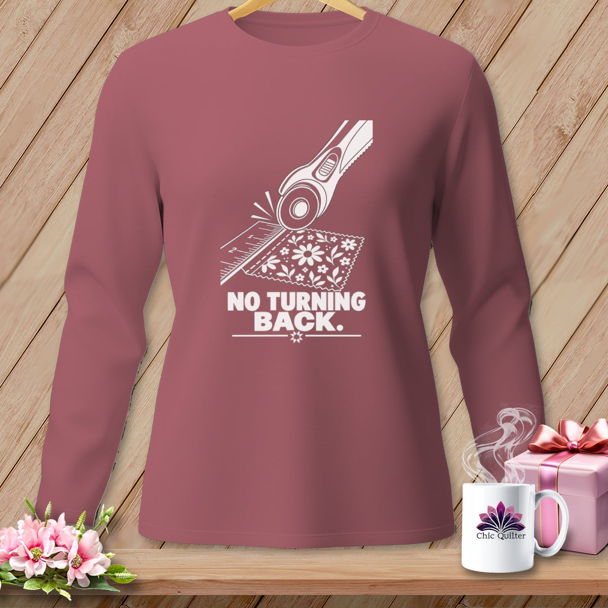 Rose long sleeve shirt with white graphic of rotary cutter and floral fabric, "NO TURNING BACK."