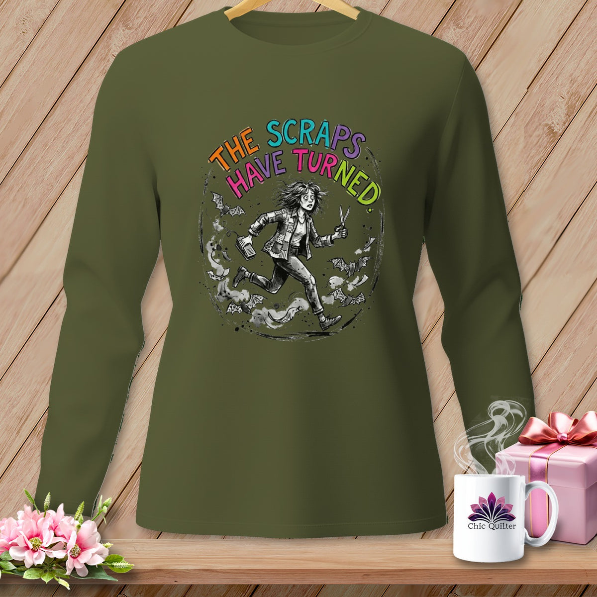 Olive green long sleeve shirt with a graphic of a running woman and bats.
