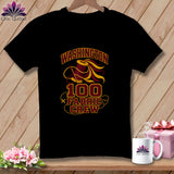 A black t-shirt hanging on a wooden wall features a graphic with a spool of thread and the text 