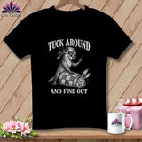 Black t-shirt featuring a graphic of an otter holding scissors and a syringe, with a tied-up rabbit, and the text TUCK AROUND AND FIND OUT.
